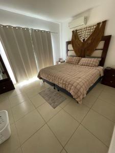 a bedroom with a bed with a wooden headboard at Casa del Conejo in Puerto Morelos +15 photos
