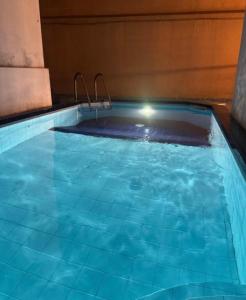 a swimming pool with blue water in a room at Natures Bliss Holidays in Ja-Ela