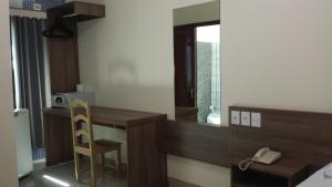 a small room with a desk and a mirror at Garcia Palace Hotel in Sinop