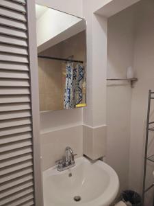 a bathroom with a sink and a mirror at Healing Minds Home in Miramar +10 photos
