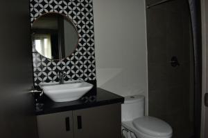 ein Badezimmer mit Waschbecken, Spiegel und Toilette in der Unterkunft Chihuahua Historic Suite in Chihuahua + 13 Fotos