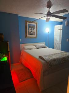 a bedroom with a bed and a ceiling fan at Healing Minds Home in Miramar