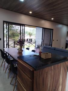 a living room with a blue couch and a table at La Cima Escondida Bijagua Rio Celeste 20 Min in Upala