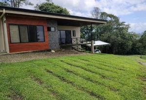 a house with a large lawn in front of it at La Cima Escondida Bijagua Rio Celeste 20 Min in Upala