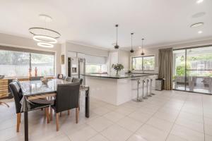 a kitchen and dining room with a table and chairs at Charming 3-Bed Getaway with Pool & Garden Oasis in Lyons