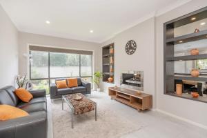a living room with a couch and a table at Charming 3-Bed Getaway with Pool & Garden Oasis in Lyons