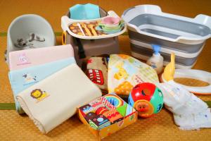 a table with a childs toys and a lunch box at Yutorelo Yamaga in Yamaga