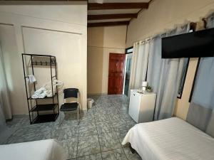 a bedroom with two beds and a mirror and a sink at Cabinas del Río in Upala