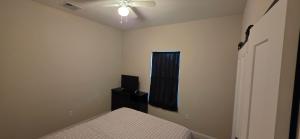 a bedroom with a bed and a television in it at Room in Downtown Orlando! Close to everything! in Orlando