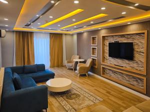a living room with a couch and a tv at yomra apart otel in Yomra