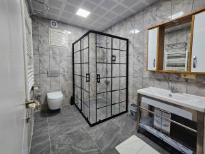 a bathroom with a shower and a toilet and a sink at yomra apart otel in Yomra +22 photos