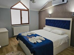a bedroom with a bed with towels on it at yomra apart otel in Yomra