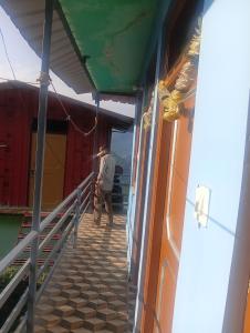 a man walking down the stairs of a building at Anik home stay in Sari
