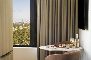 a table in a room with a window at Adina Chermside Brisbane in Brisbane