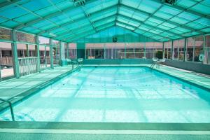 a large swimming pool in a large building at Endless Dunes, A Modern Motel in Eastham