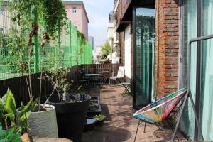 an outdoor patio with plants and a table and chairs at 마음스테이 in Taesuha-dong