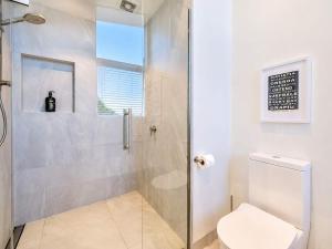 a bathroom with a shower and a toilet at Oneroa Vines and Views- Stay Waiheke in Blackpool
