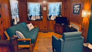 a living room with a couch and a chair and a television at 4-OH, DEER! - Historic Five Points Lake Hamilton in Hot Springs
