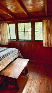 a bedroom with a bed and a wooden floor at 4-OH, DEER! - Historic Five Points Lake Hamilton in Hot Springs