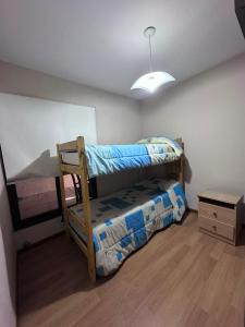 a bedroom with two bunk beds and a table at Casa nueva centrica in San Rafael