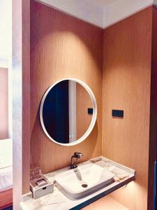 a bathroom with a sink and a mirror at Kim Thành Hotel in Bắc Ninh
