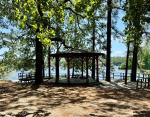 a gazebo next to a body of water at 4-OH, DEER! - Historic Five Points Lake Hamilton in Hot Springs