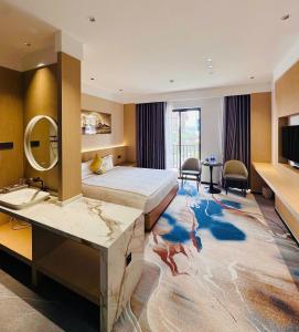 a hotel room with a large bed and a mirror at Kim Thành Hotel in Bắc Ninh