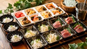 a tray filled with different types of food on a table at Capsule Inn Osaka (Male Only) in Osaka