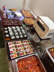 a table with many different types of food on it at Capsule Inn Osaka (Male Only) in Osaka +62 photos