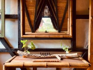 a window in a room with a wooden table at La Caleta House in Mompiche
