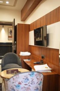 a room with a table and a chair and a tv at Hotel Jai Palace in Ajmer +44 photos