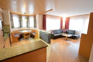 a large living room with a couch and a table at Helvetia Apartments in Saas-Fee