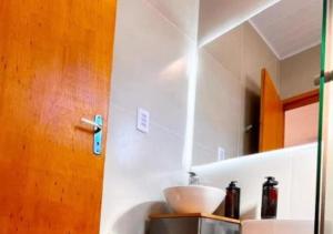 a kitchen with a sink and a bowl on a counter at São Gabriel Centro Studios & Suítes in São Gabriel +14 photos
