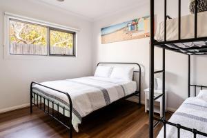 a bedroom with two bunk beds and a window at Luxury Capel Sound in Rye