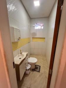 a bathroom with a toilet and a sink at New progress, it's Félix! in Marabá