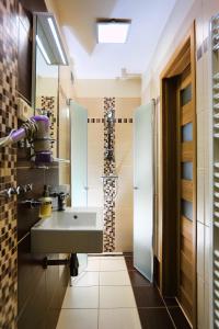 a bathroom with a sink and a mirror at Pod Dubom in Liptovský Mikuláš
