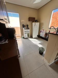 a kitchen with a refrigerator and a tile floor at New progress, it's Félix! in Marabá