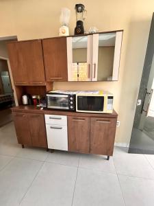 a kitchen with a microwave sitting on top of a counter at New progress, it's Félix! in Marabá