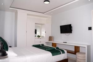 a bedroom with a bed and a tv on a wall at Kingston Horizon Retreat in Kingston