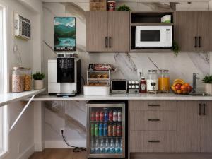 a kitchen with a refrigerator with drinks in it at Paradise Motel in Sicamous