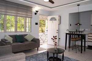 a living room with a couch and a table at Kingston Horizon Retreat in Kingston