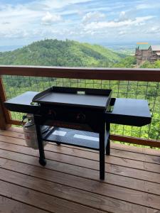 a grill on a deck with a view of a mountain at Million Dollar Views with Hot Tub and Pool Near Dollywood in Sevierville