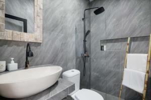 a bathroom with a sink and a toilet and a shower at Kubu YN Bali in Jimbaran +27 photos