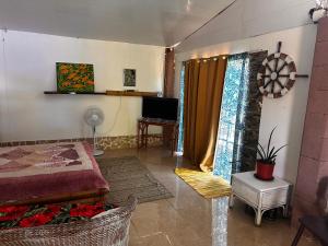 a bedroom with a bed and a television in a room at Kukuriaz Fare in Bora Bora