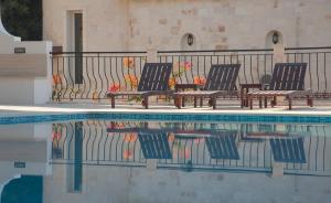 a group of chairs sitting next to a swimming pool at Luxury Villa Caretta in Kaş