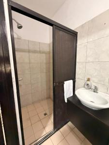 a bathroom with a sink and a shower at Marena paradise, loft escondido,wifi,piscina12 in La Libertad