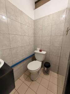 a small bathroom with a toilet and a sink at Marena paradise, loft escondido,wifi,piscina12 in La Libertad +4 photos