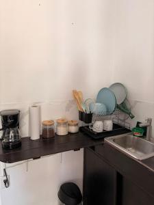 a kitchen counter with plates and utensils on it at Marena paradise, loft escondido,wifi,piscina12 in La Libertad