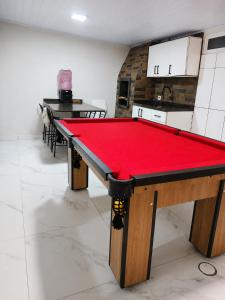 a ping pong table with a red cloth on it at House Pontal do Paraná in Pontal do Paraná +3 photos