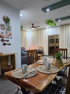 a wooden table with plates and cups on it in a living room at Little Heaven Villa in Lomé